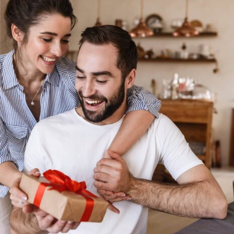 attractive-brunette-couple-man-woman-having-breakfast-apartment-while-sitting-table-with-present-box (1)