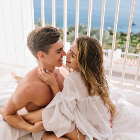 happy-long-haired-girl-gently-embracing-her-smiling-boyfriend-going-kiss-him-beautiful-young-couple-cute-hugging-laughing-while-resting-bed-sunny-morning-sea-resort (1)